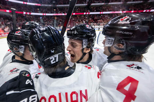 Beau Akey celebrates with Easton Cowan of Canada who scored