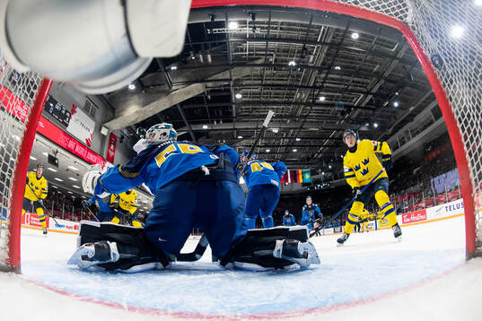 Anton Wahlberg of Sweden scores 6-0 behind goaltender