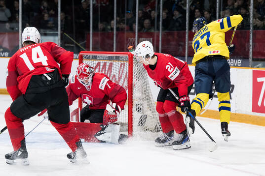 David Granberg of Sweden scores 1-4 behind goaltender
