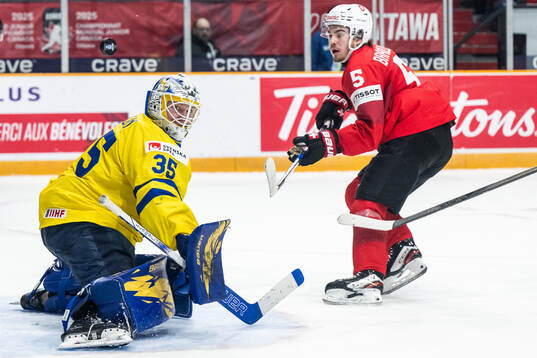 Goaltender Melker Thelin of Sweden with a save against Leo