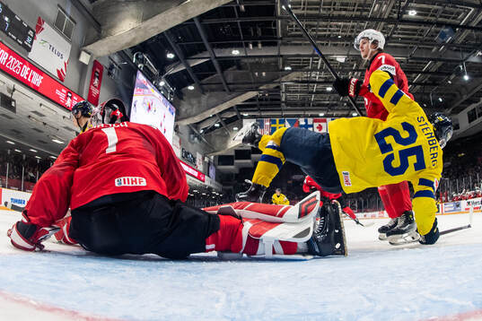 Goaltender Christian Kirsch and Timo Bunzli of Switzerland