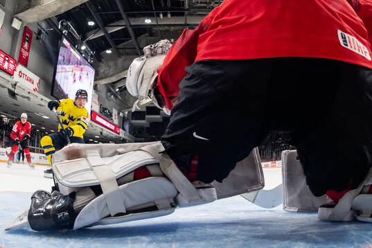 Zeb Forsfjäll of Sweden scores 1-2 behind goaltender