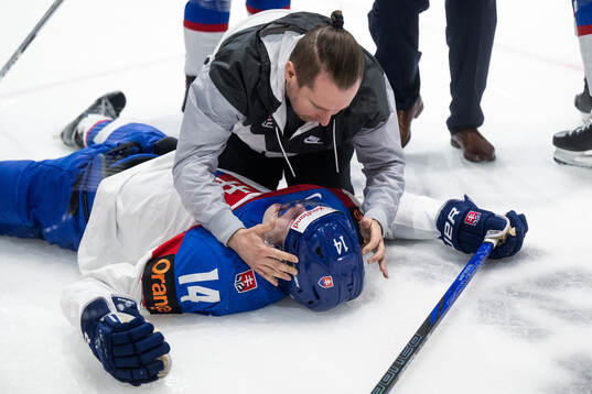 Miroslav Satan of Slovakia receives medical attention