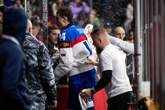 Miroslav Satan of Slovakia leaves the ice due to injury