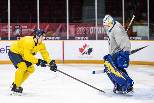 David Edstrom and goaltender Melker Thelin of Sweden at a