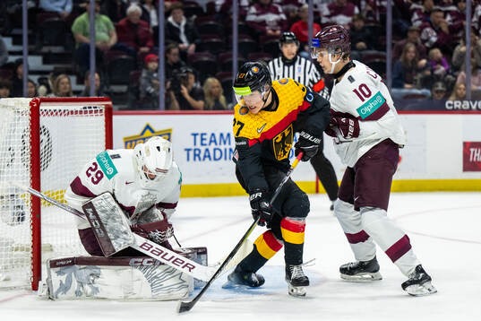 Goaltender Linards Feldbergs and Harijs Cjunkis of Latvia
