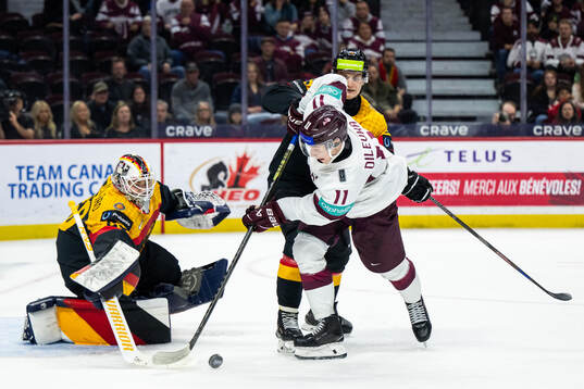 Goaltender Linus Vieillard and Paul Mayer of Germany