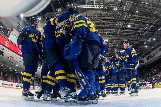 Goaltender Melker Thelin of Sweden celebrates with team