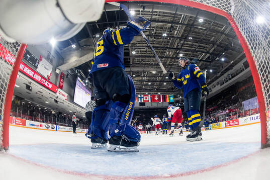 Goaltender Melker Thelin of Sweden celebrates with Axel