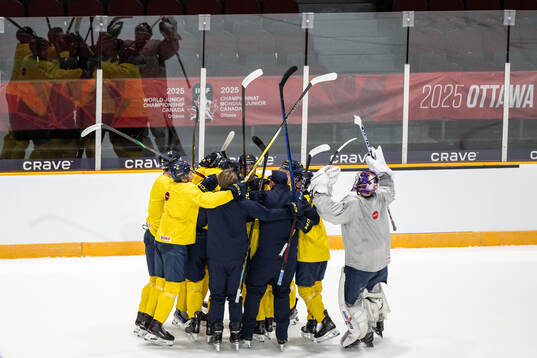 Players and coaches of Sweden celebrate at a practice