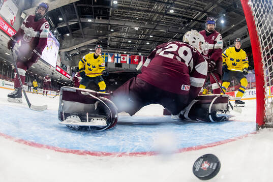 David Edstrom of Sweden scores a goal behind goaltender