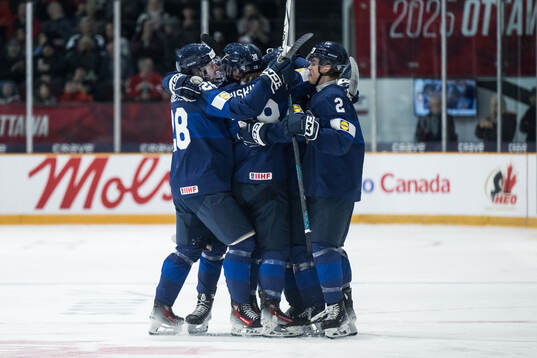 Jesse Nurmi of Finland celebrates with team mates