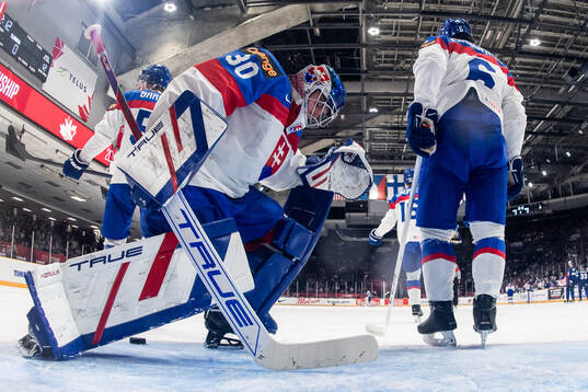 Goaltender Samuel Urban and Jakub Chromiak of Slovakia look