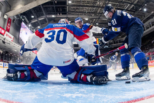 Topias Hynninen of Finland scores a goal behind goaltender