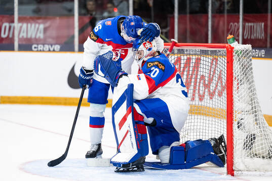 Roman Kukumberg and goaltender Samuel Urban of Slovakia