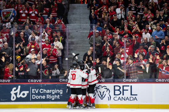 Porter Martone of Canada celebrates with team mates