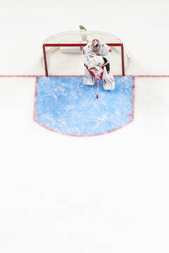 Goaltender Carter George of Canada looks dejected