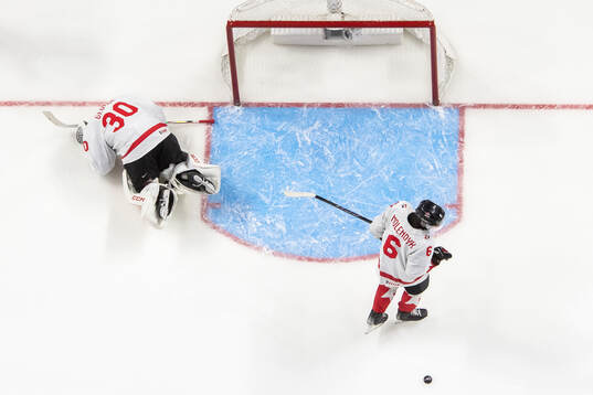 Goaltender Carter George and Tanner Molendyk of Canada look