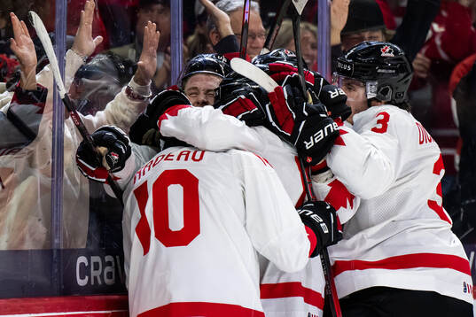 Bradly Nadeau of Canada celebrates with team mates