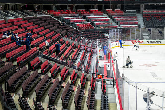 Players and coaches of Sweden watch a practice session of