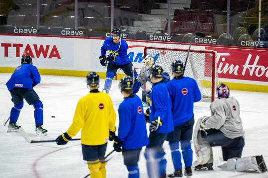 Anton Wahlberg and goaltender Melker Thelin of Sweden at a