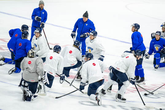 Head coach Lauri Mikkola of Finland talks to players at a