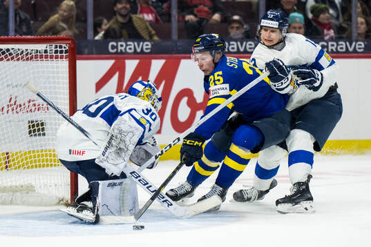 Goaltender Petteri Rimpinen and Veeti Väisänen of Finland