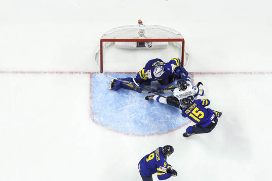 Arrtu Alasiurua of Finland scores the 2-3 goal behind
