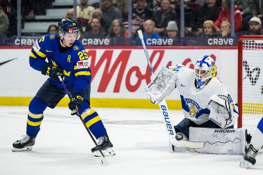Otto Stenberg of Sweden and goaltender Petteri Rimpinen of