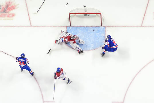 Cole Hutson of USA, Jakub Fibigr and goaltender Michael