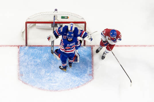 Goaltender Trey Augustine and Max Plante of USA celebrate