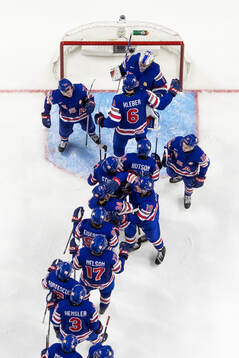 Goaltender Trey Augustine of USA celebrates with team mates