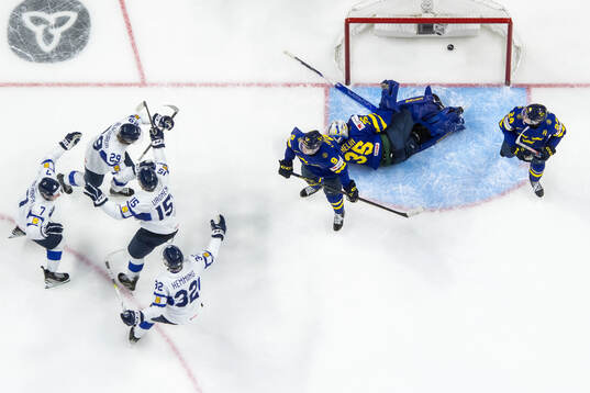 Arrtu Alasiurua of Finland celebrates with team mates