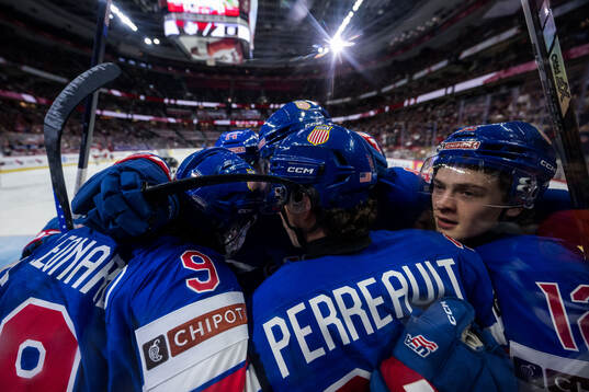 Gabe Perreault of USA celebrates with team mates