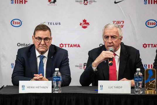 Heikki Hietanen council member of IIHF and Luc Tardif