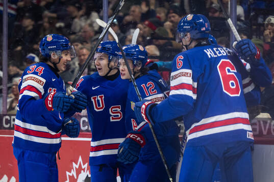 James Hagens of USA celebrates with team mates