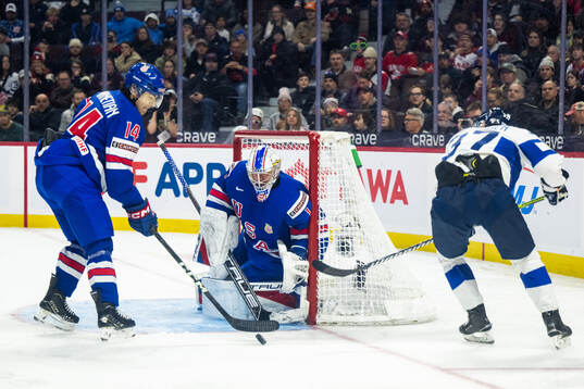 Aram Minnetian and goaltender Trey Augustine of USA against