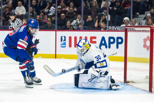 Ryan Leonard of USA and goaltender Petteri Rimpinen of