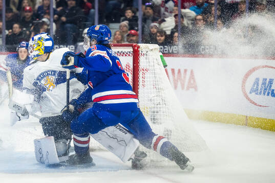 Goaltender Petteri Rimpinen of Finland and Ryan Leonard of