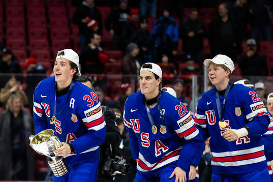 Gabe Perreault of USA celebrates with the trophy