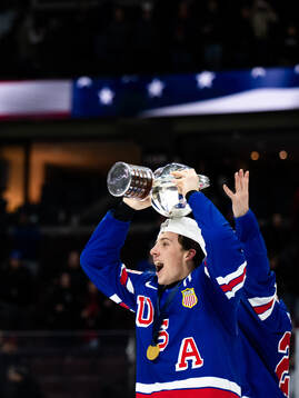 Gabe Perreault of USA celebrates with the trophy