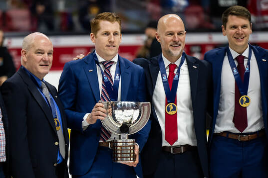 Head coach David Carle of USA celebrates with the trophy