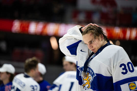 goaltender Petteri Rimpinen of Finland looks dejected