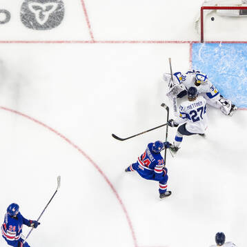 Cole Hutson of USA scores 3-3 behind Julius Miettinen and