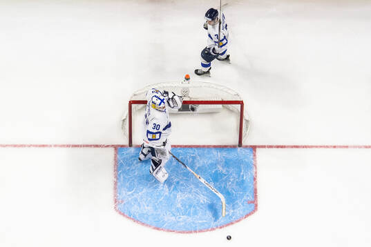 Daniel Nieminen and goaltender Petteri Rimpinen of Finland