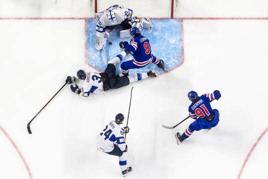 Kalle Kangas and goaltender Petteri Rimpinen of Finland