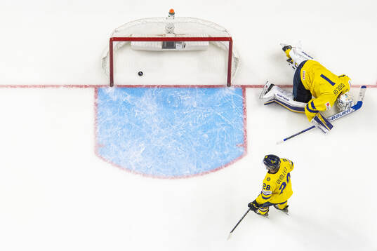 Oskar Voullet and goaltender Marcus Gidlöf of Sweden look