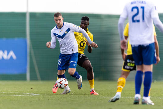 Lukasz Wolsztynski of FKS Stal Mielec and Ibrahim Buhari of