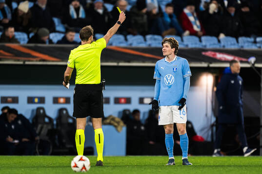 Oliver Berg of Malmö FF receives a yellow card by Referee