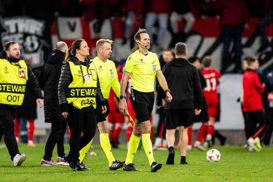 Referee Sascha Stegemann is being escorted of the pitch